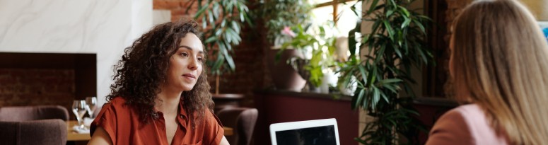 two women in a plant filled office participating in a job interview
