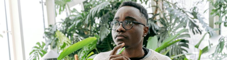 Plant tech writing care notes in a journal