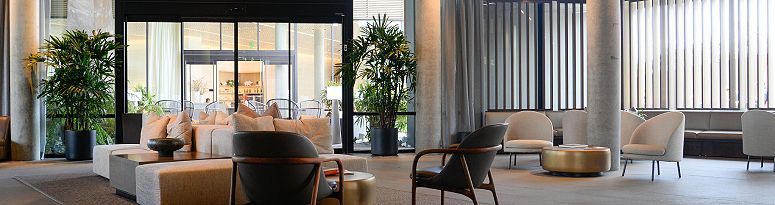 An elegant modern lobby with lush indoor plants